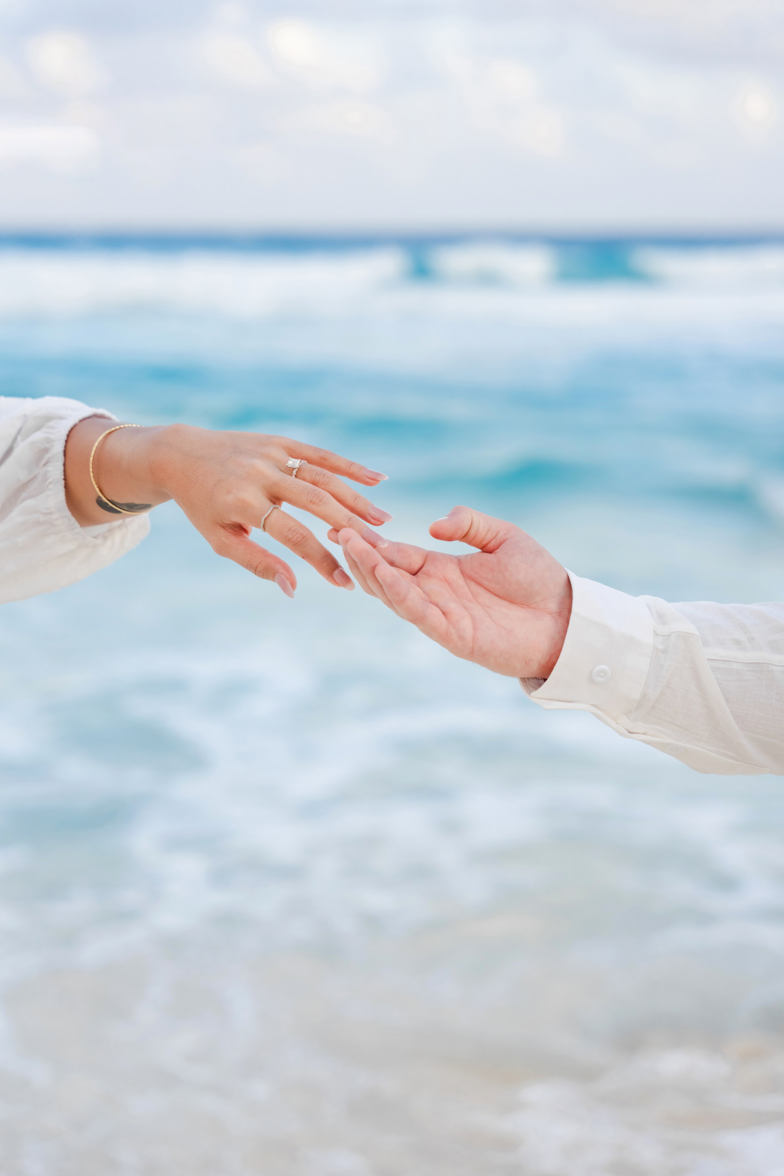 Couple barefoot on Cancun sand at sunset