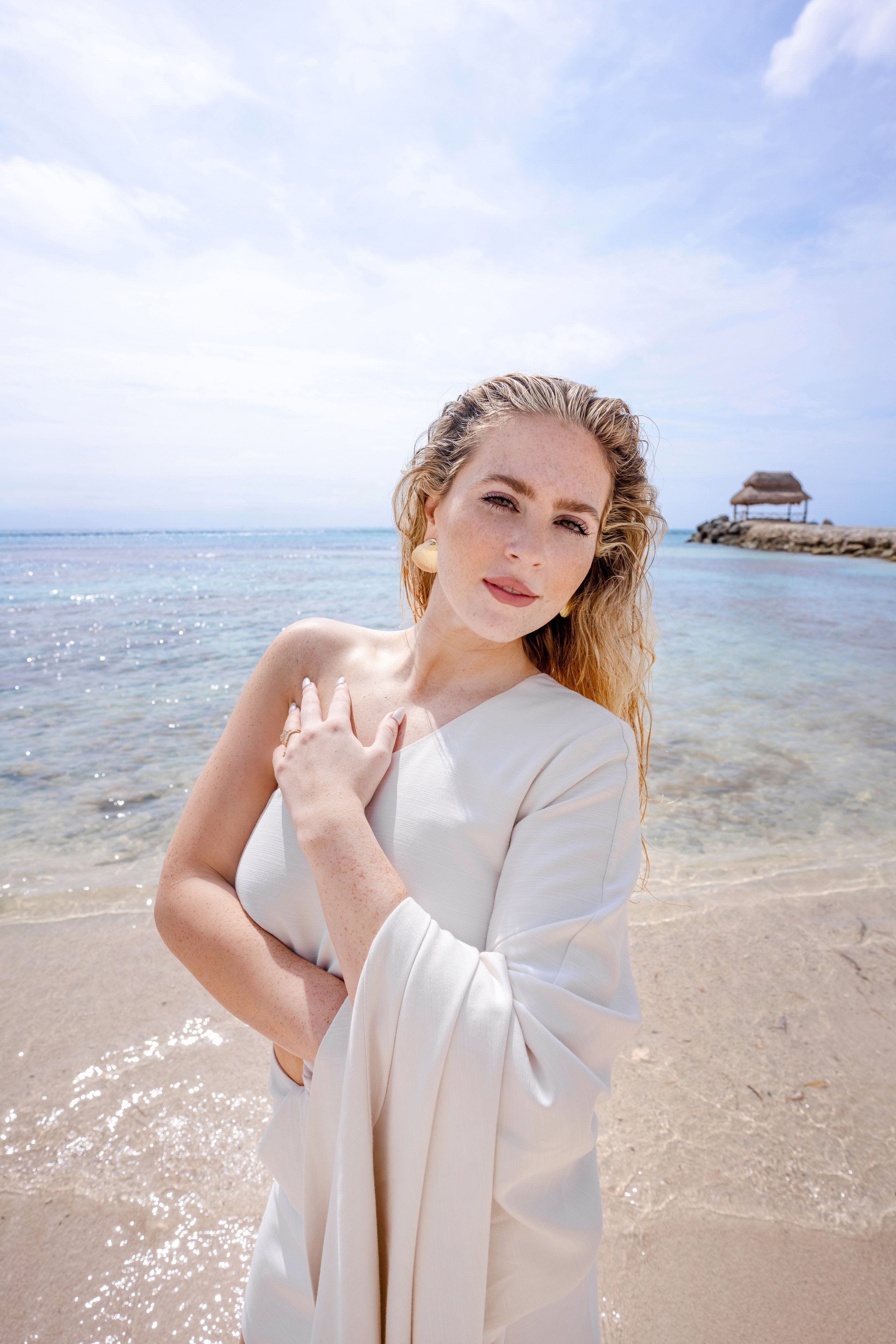 A lookbook frame on the Cancun coast at golden hour, photographed by IVAE Studios.