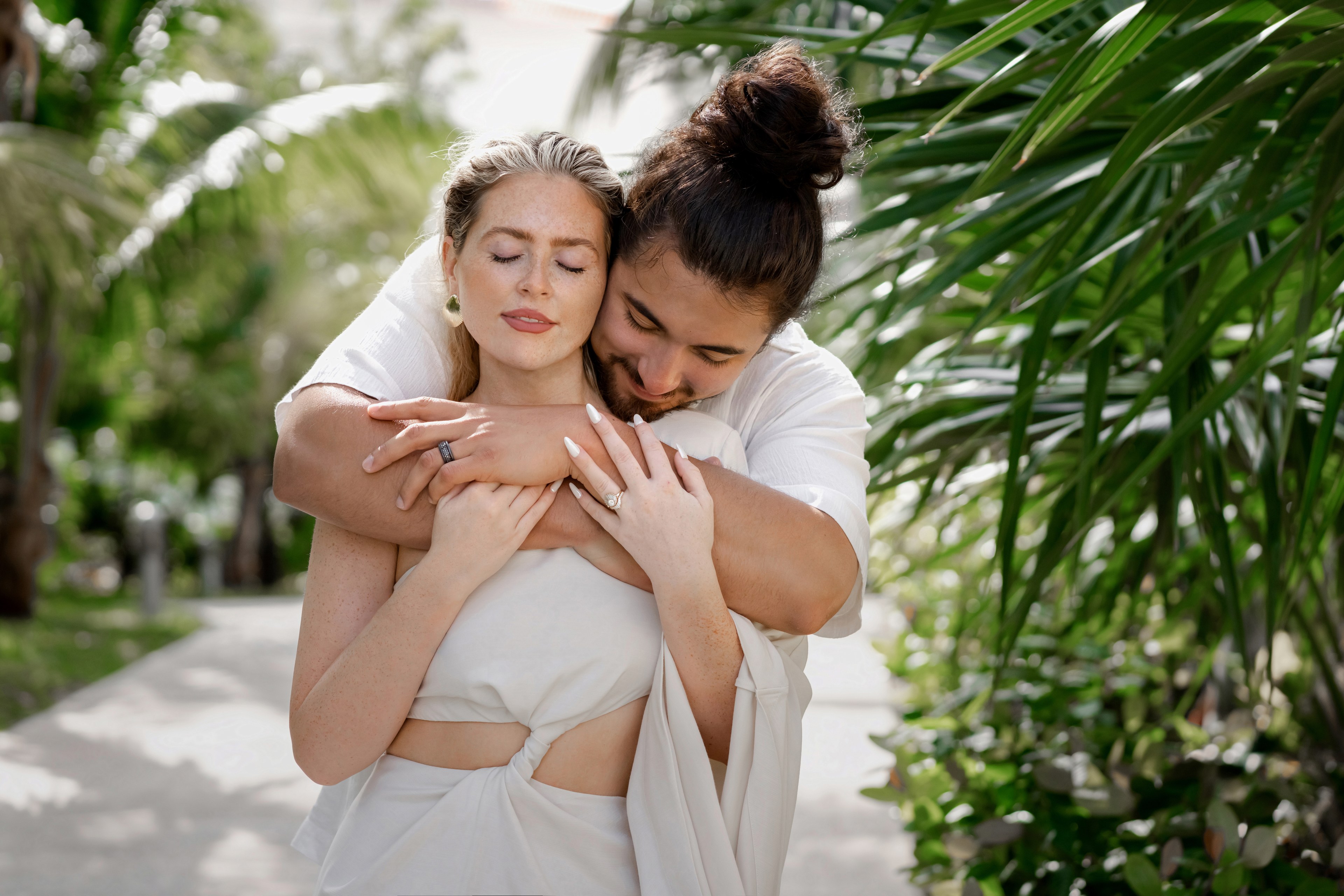 Couple at the Cancún Hotel Zone laughing during a beach session by IVAE Studios
