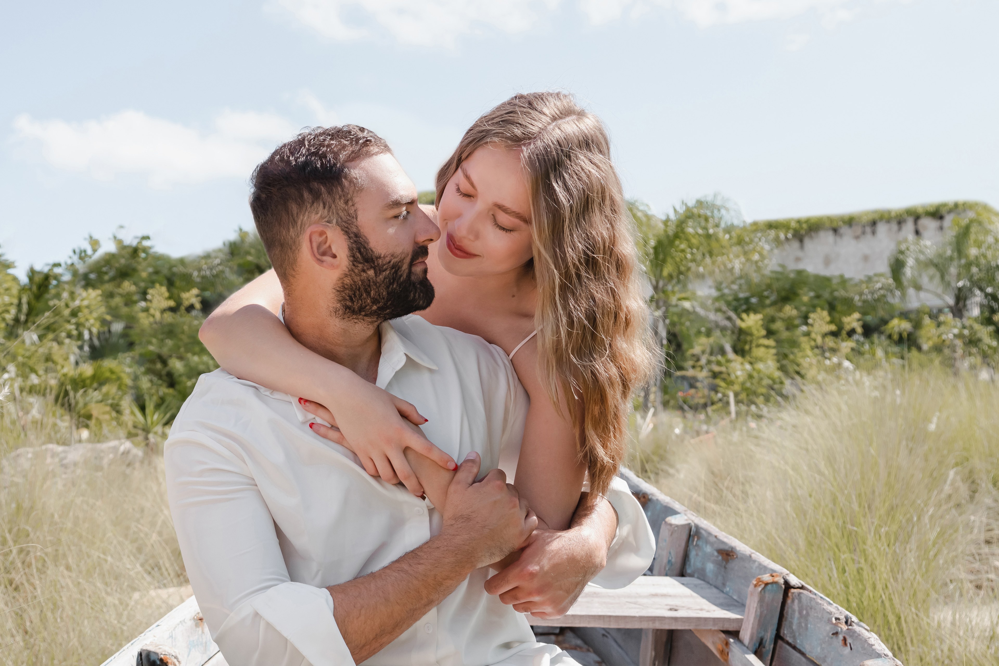 Couple embracing on an empty Isla Mujeres shoreline as the first light of the day catches the water behind them, photographed by IVAE Studios