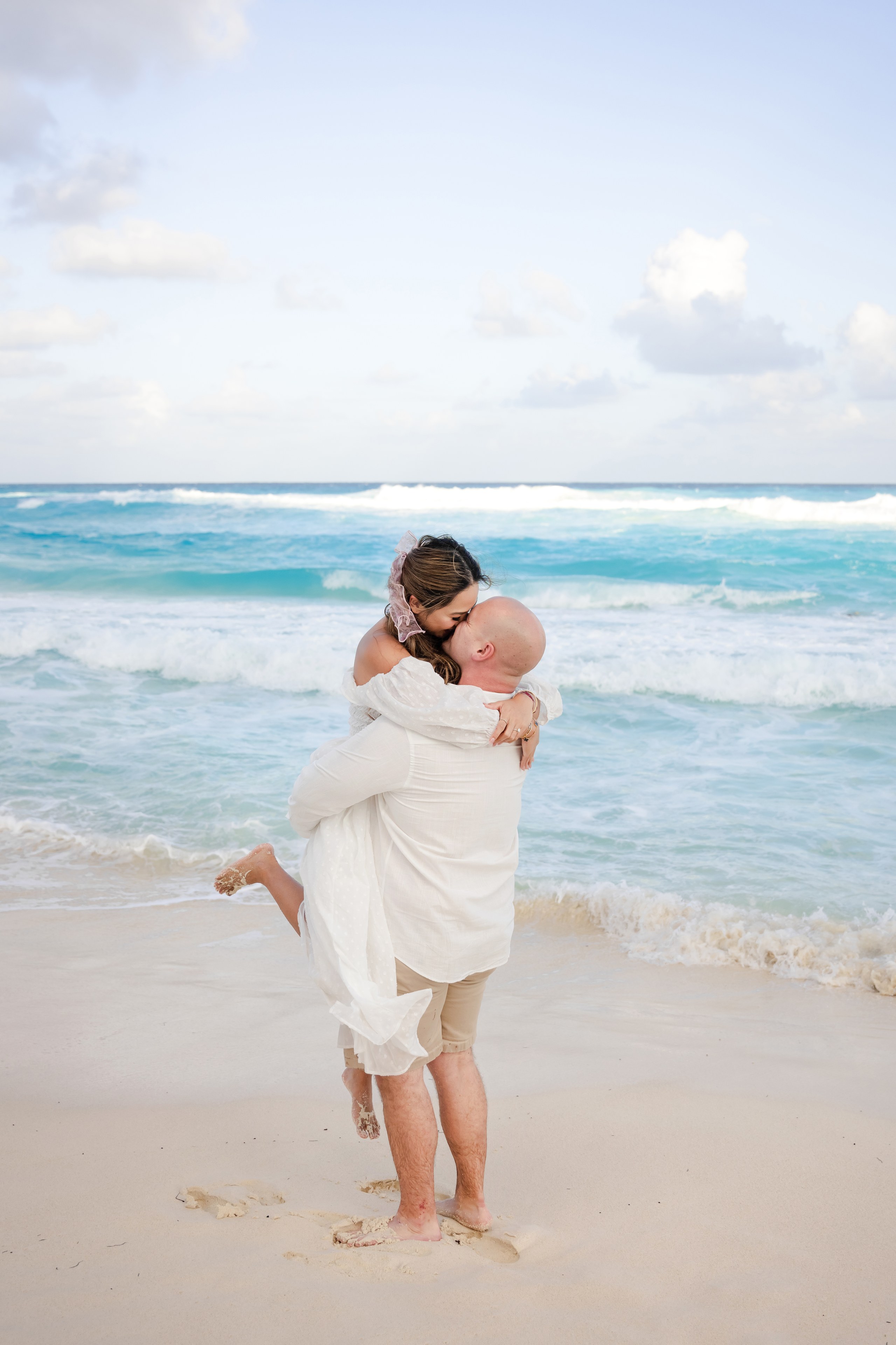 Couple at Playa Mujeres in a romantic resort setting by IVAE Studios