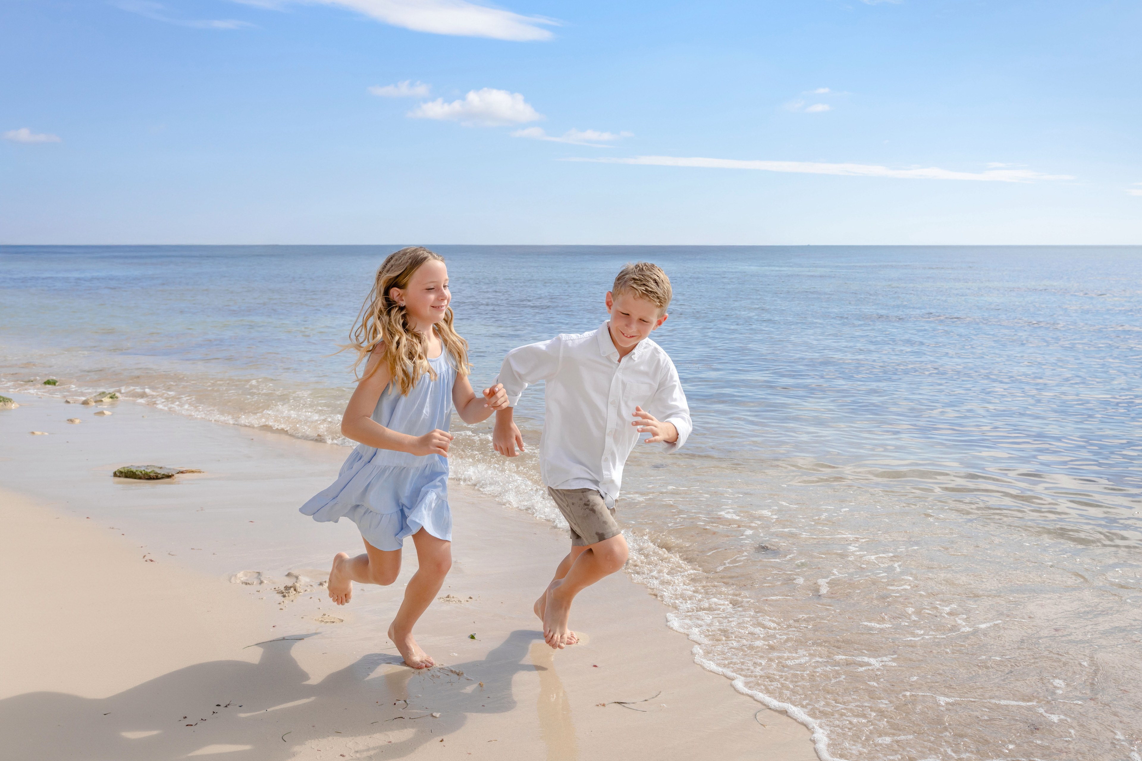 Mother with daughters during a luxury resort family session on Isla Mujeres by IVAE Studios
