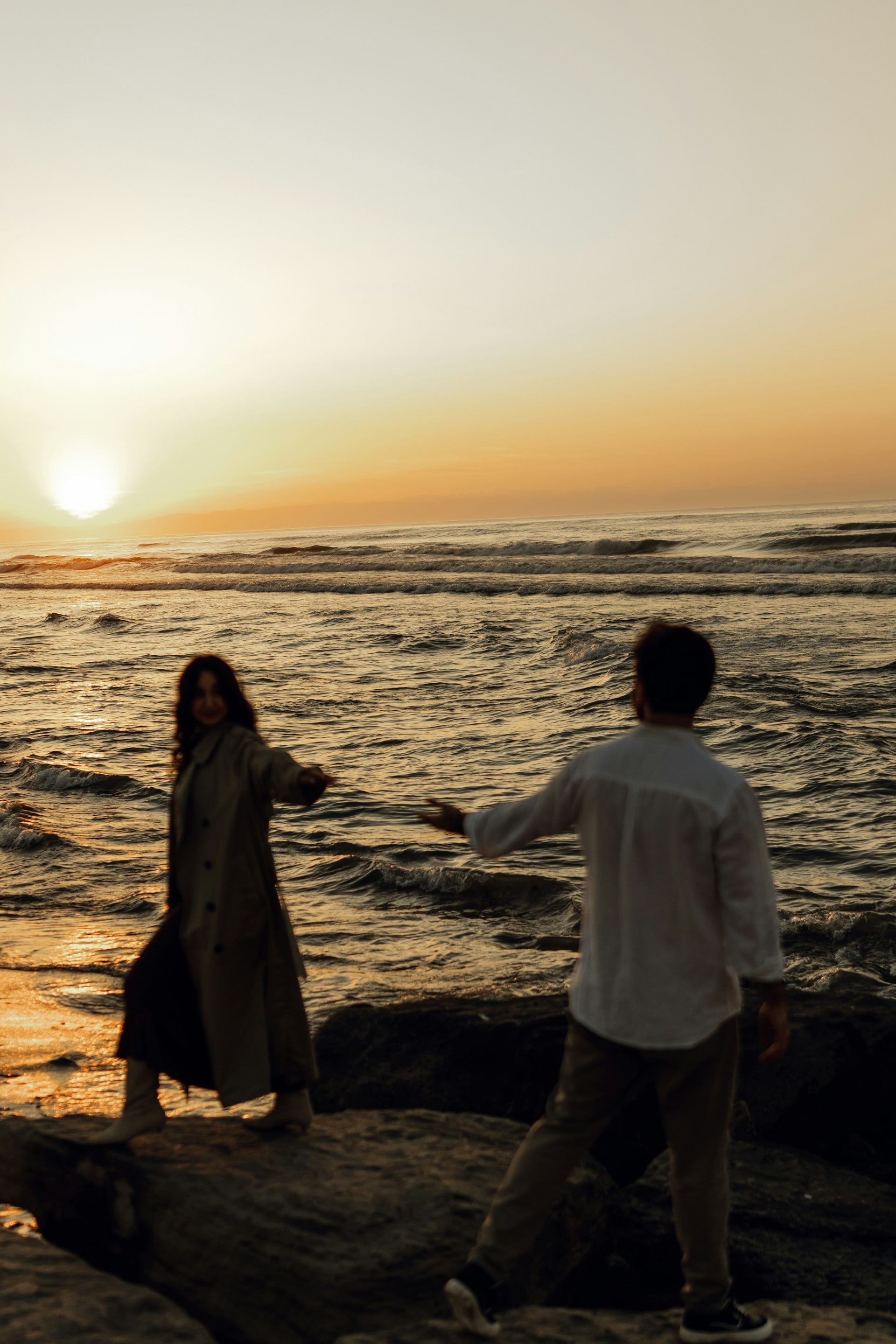 Luxury couple portrait at sunset on the cliffs of Cabo San Lucas with the Pacific Ocean and El Arco in the background