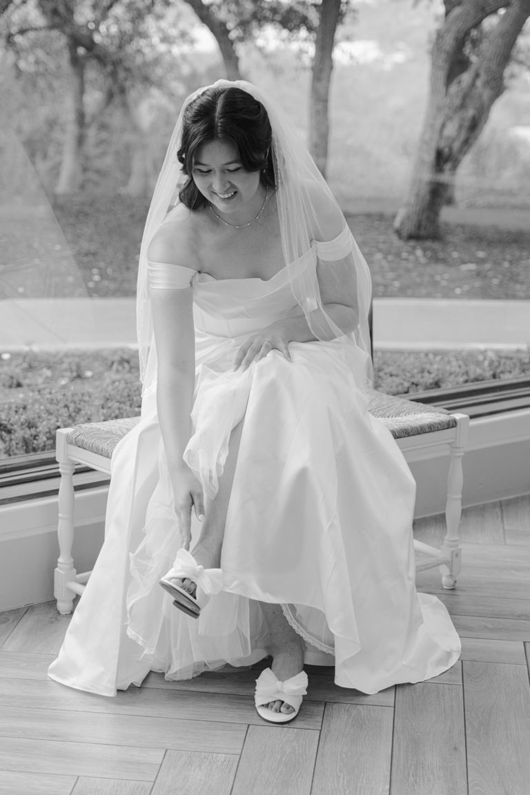 Kailyn putting on her shoes, in black and white