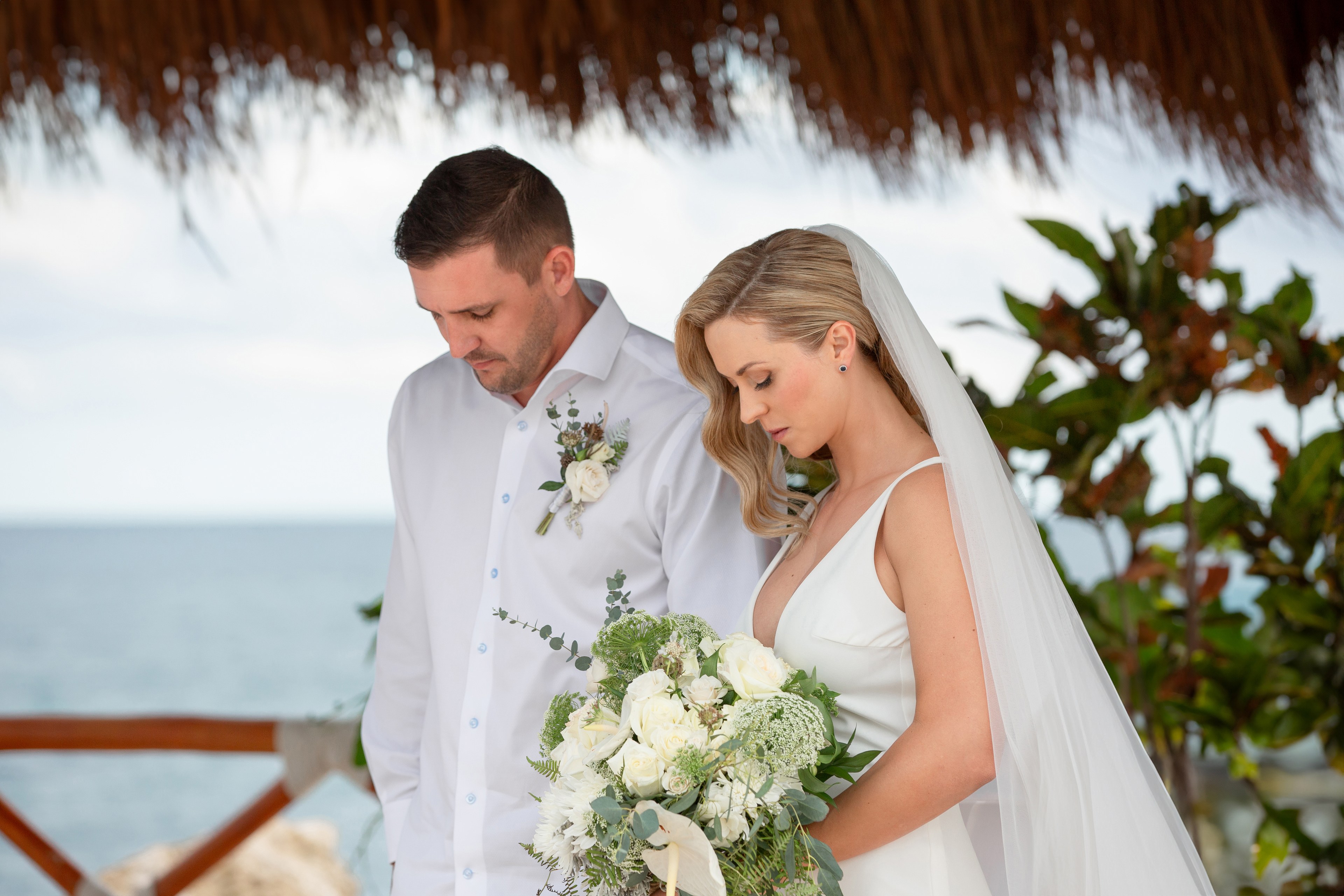 Bridal dress hanging in Cancún hotel suite by IVAE Studios