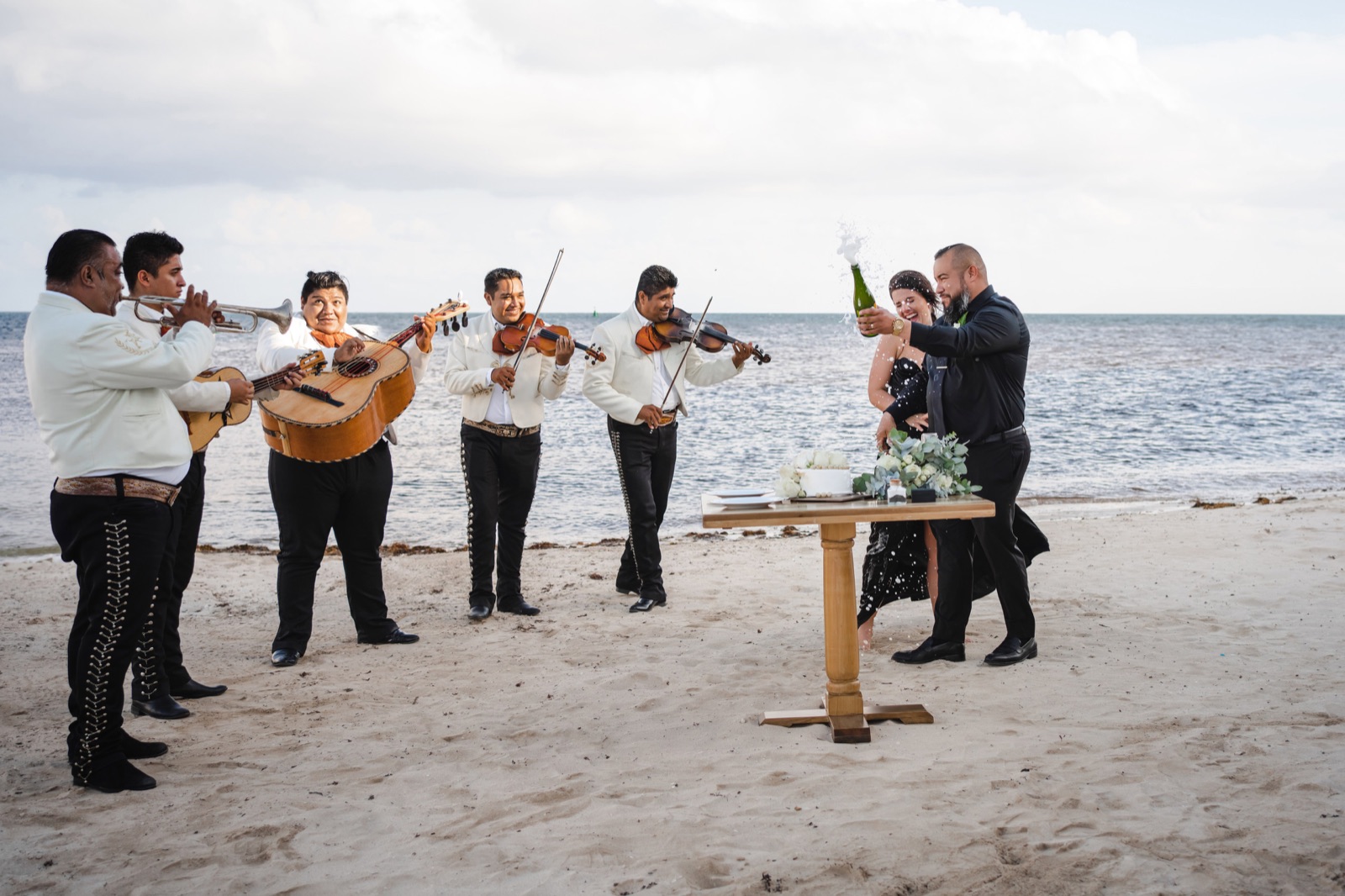 Bride on a Cancun resort beach at golden hour, photographed by an outside wedding photographer approved by the hotel