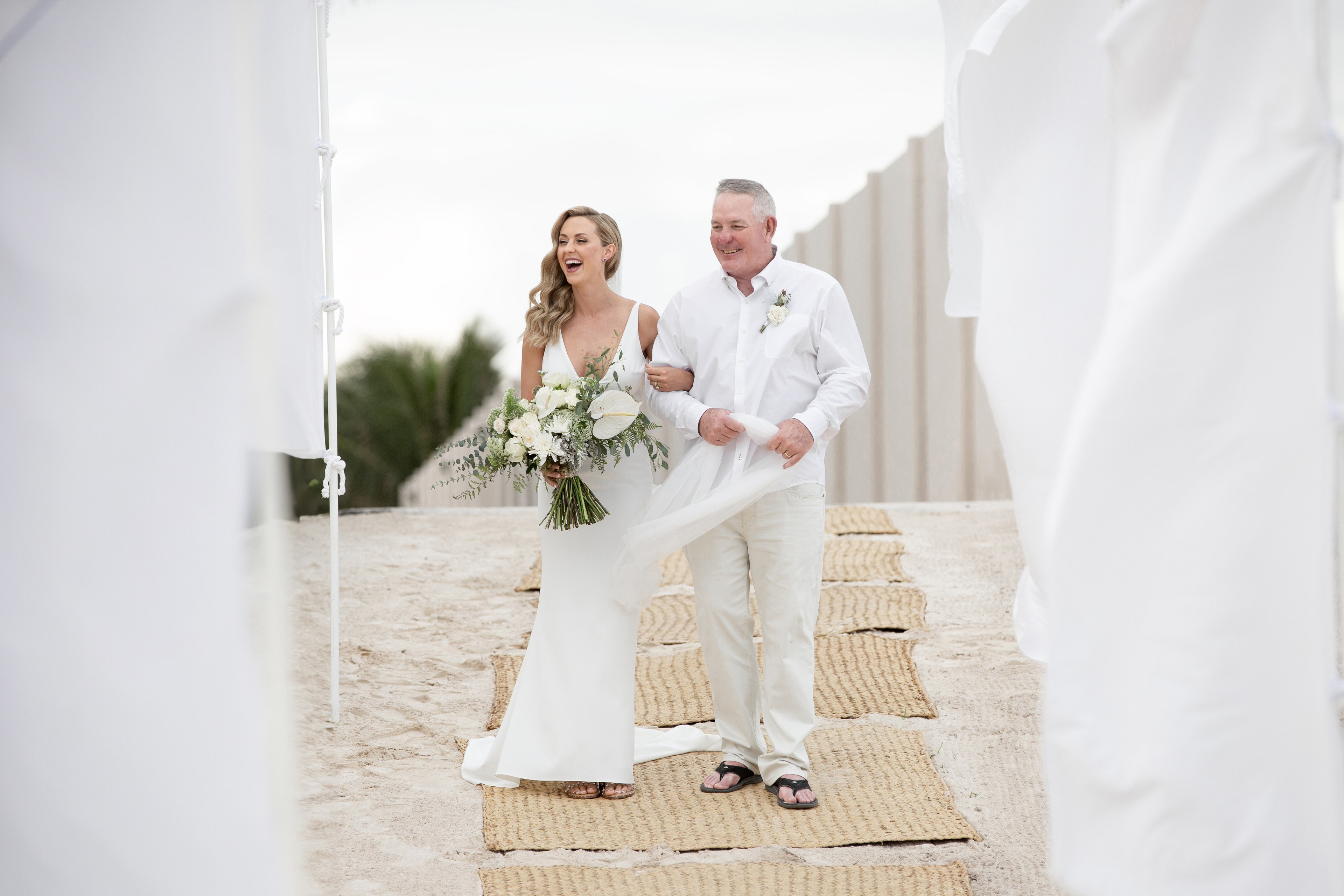 Bride on beach at Cancun resort wedding by IVAE Studios
