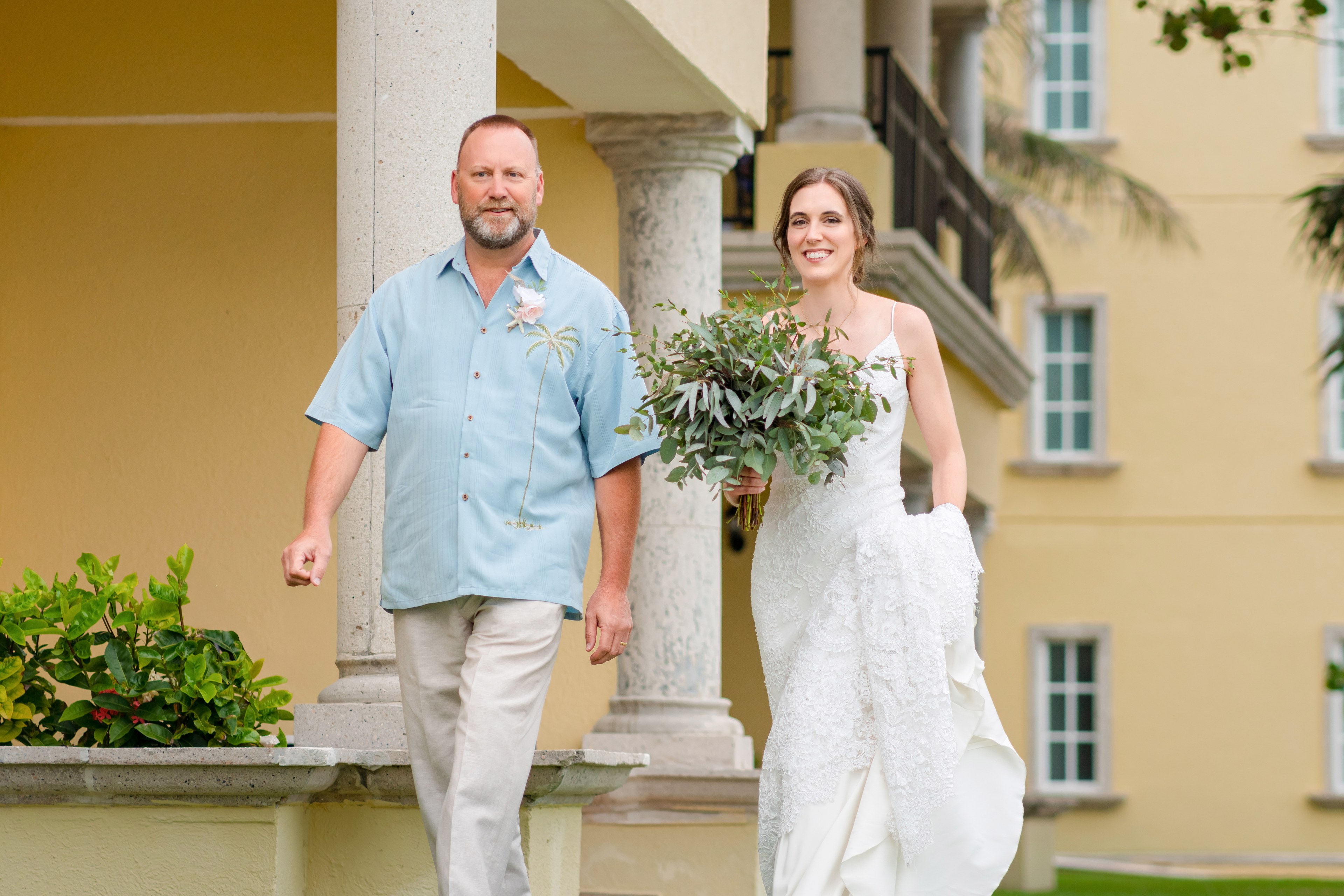 A bride and groom photographed at golden hour by IVAE Studios on a Cancun resort beach, with destination wedding guests gathered behind them in the Riviera Maya, Mexico.