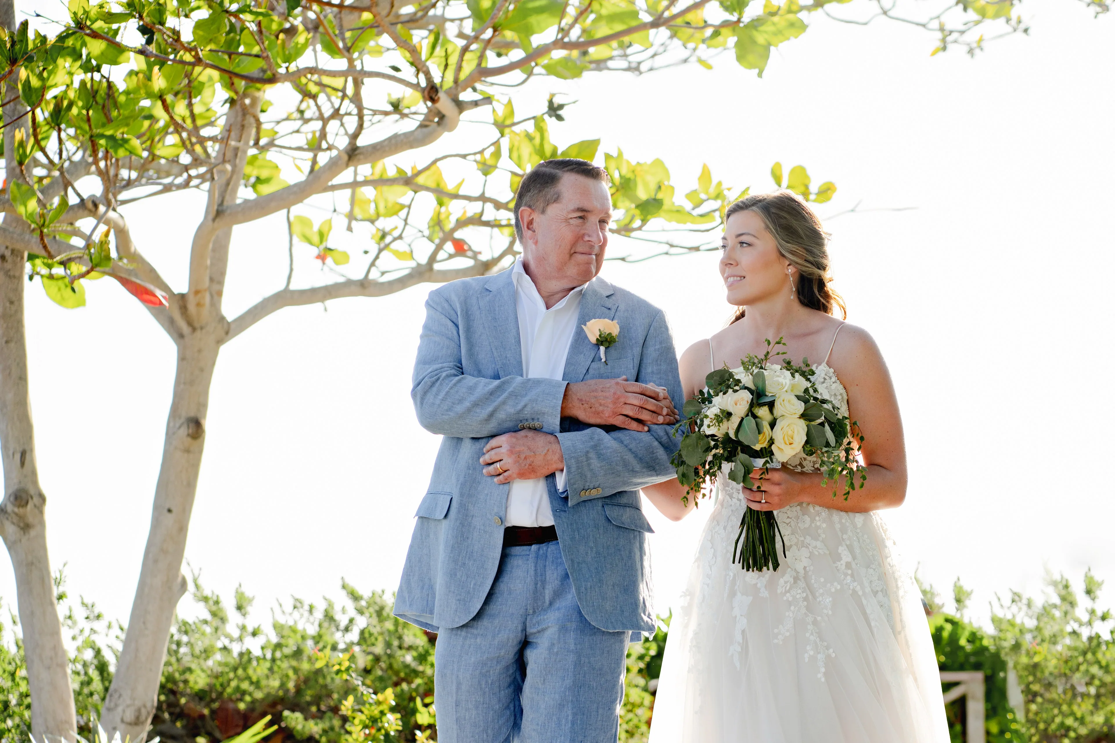 IVAE Studios golden-hour photograph of a couple on a Cancun beach in the Riviera Maya, Mexico, illustrating a wedding-travel planning guide on passport and FMM entry rules