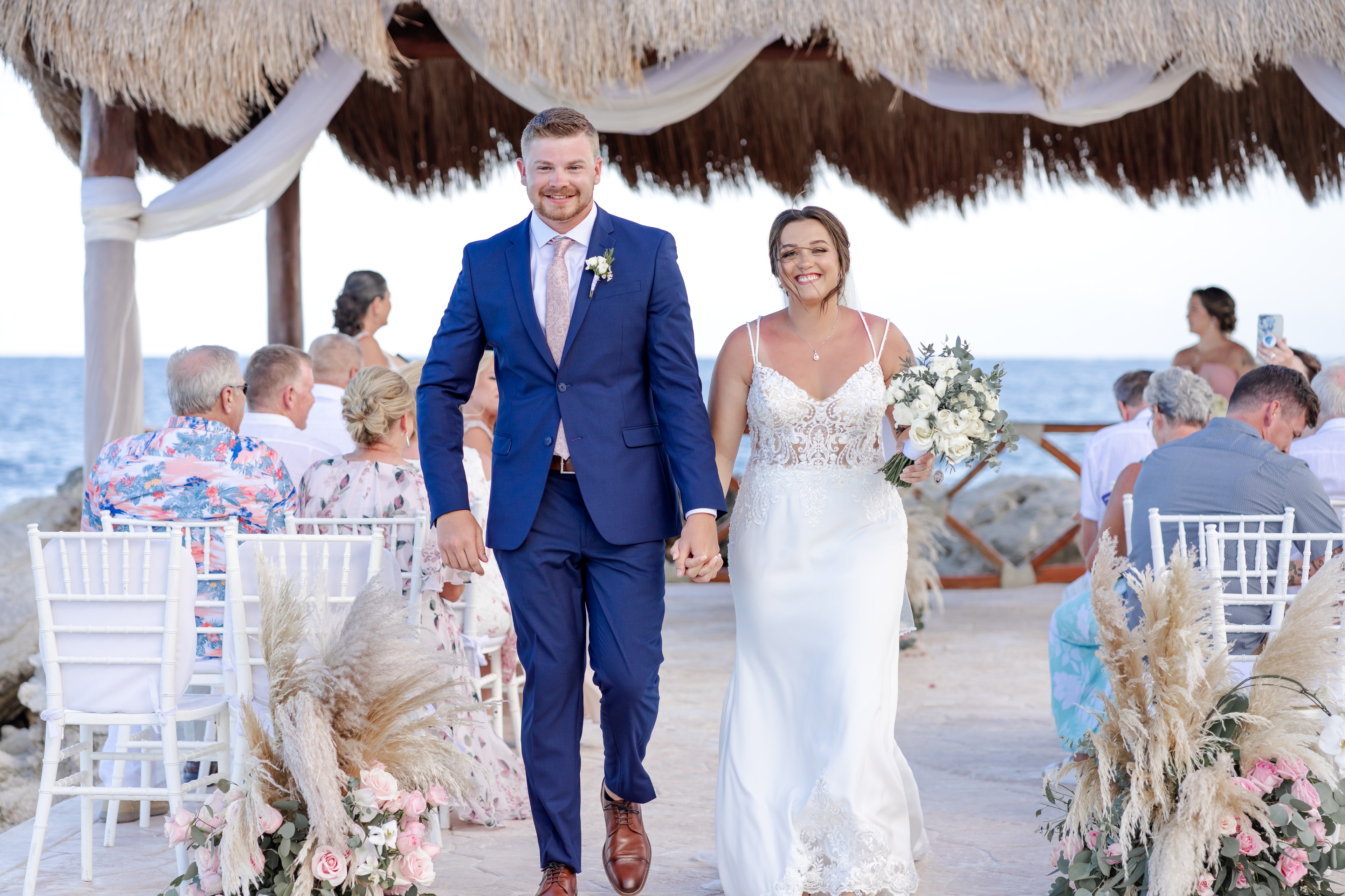 Groom photographed on an open Caribbean beach with a clean horizon behind, Riviera Maya coastline