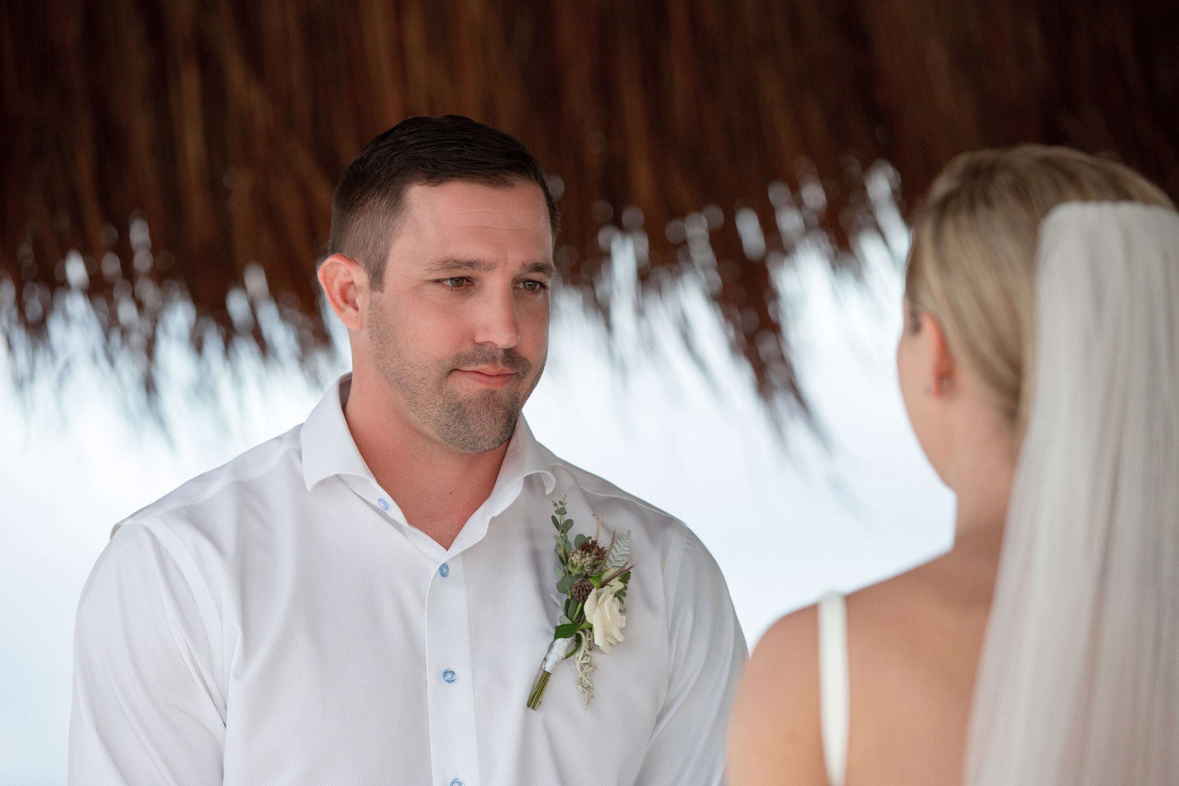 Groom reception candid laugh Cancún beach IVAE Studios wedding photo