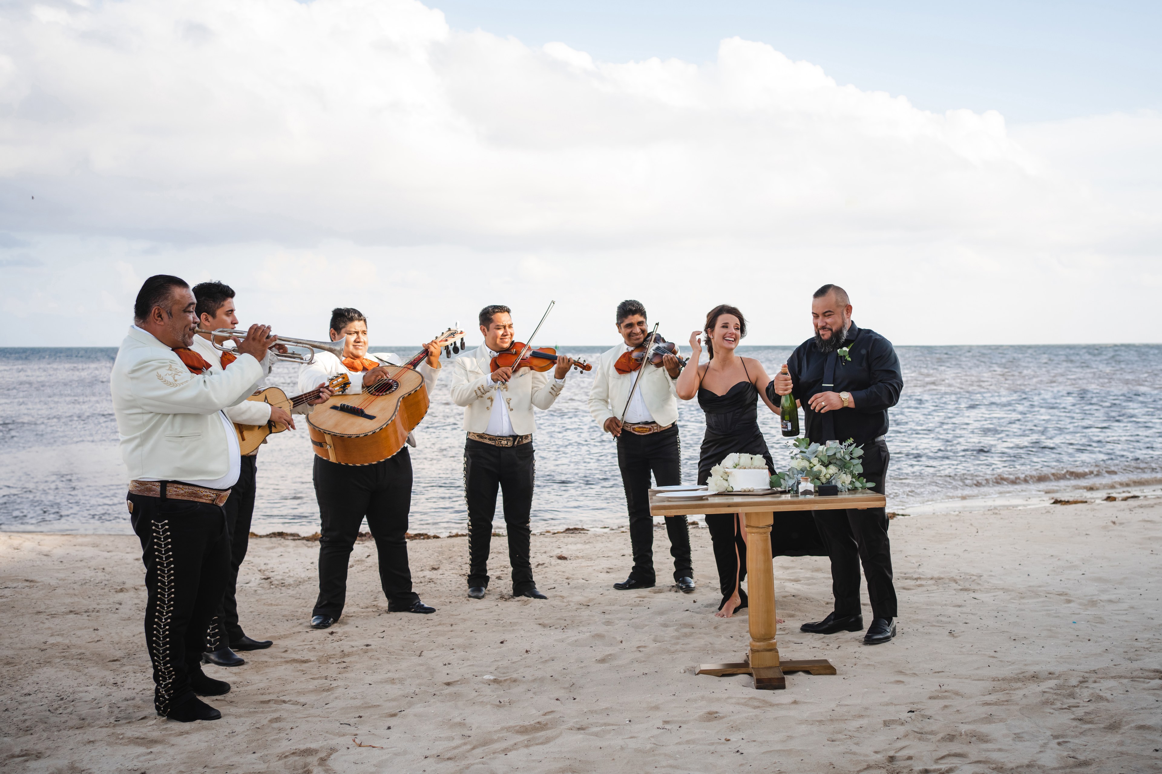 Groom in a light neutral suit photographed in the Cancun Hotel Zone, showing how warm tones sit against the pale sand and turquoise water
