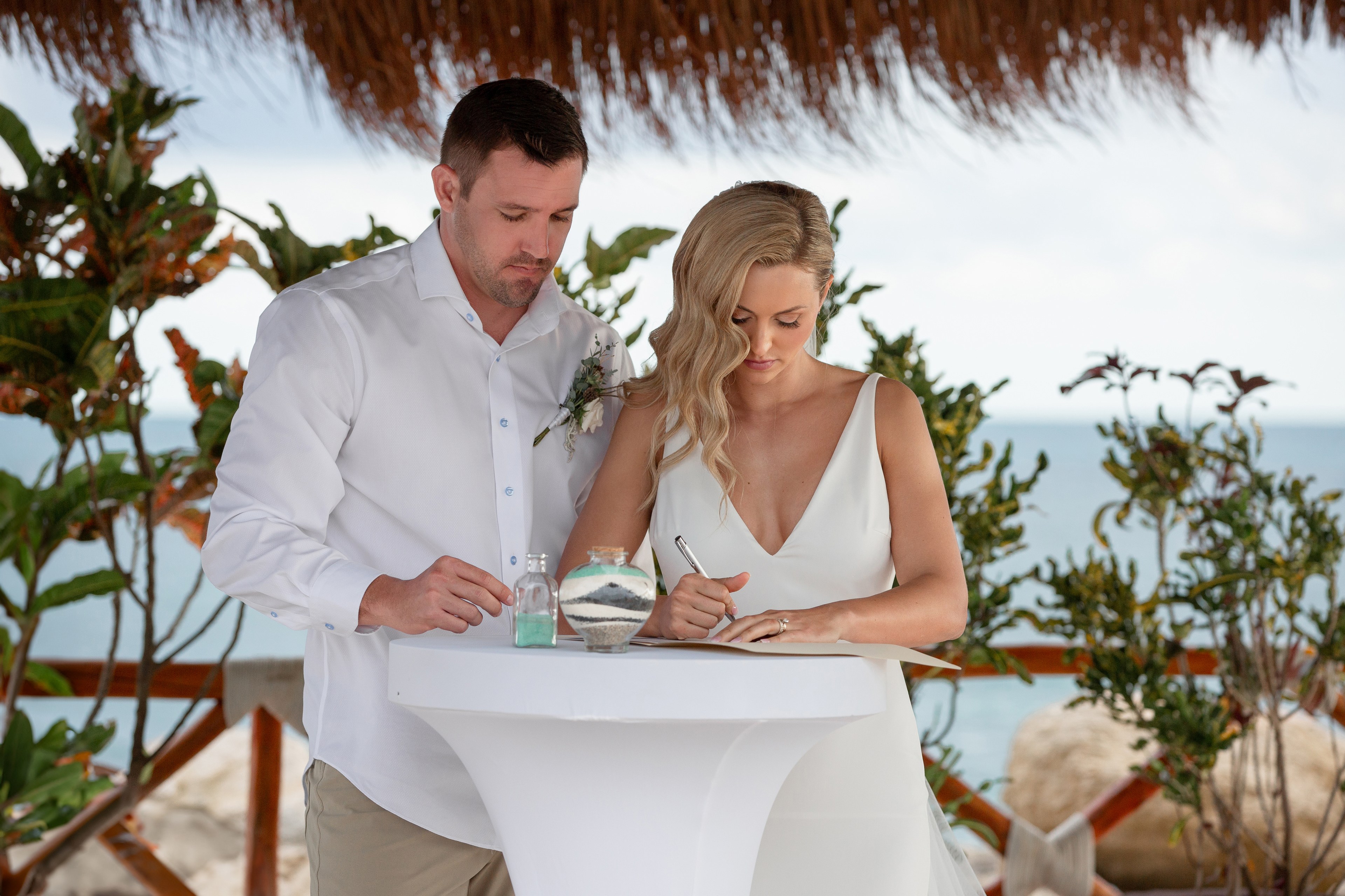 Groom buttoning suit jacket Cancún Hotel Zone IVAE Studios wedding photographer
